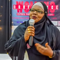The host speaking at a Top Lady event