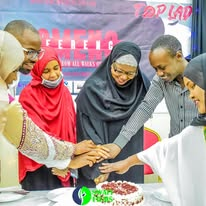 Women cutting a cake together at a Top Lady event